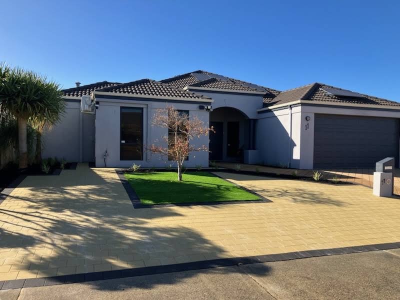 Landscaped front yard with new paving and lawn by The Garden Makers