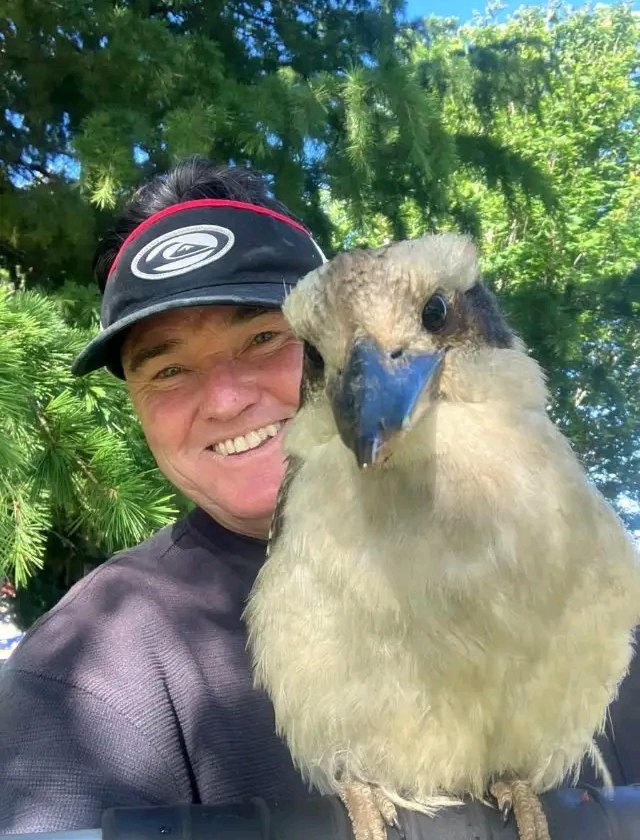 Kevin, owner of The Garden Makers, smiling with a kookaburra on his shoulder